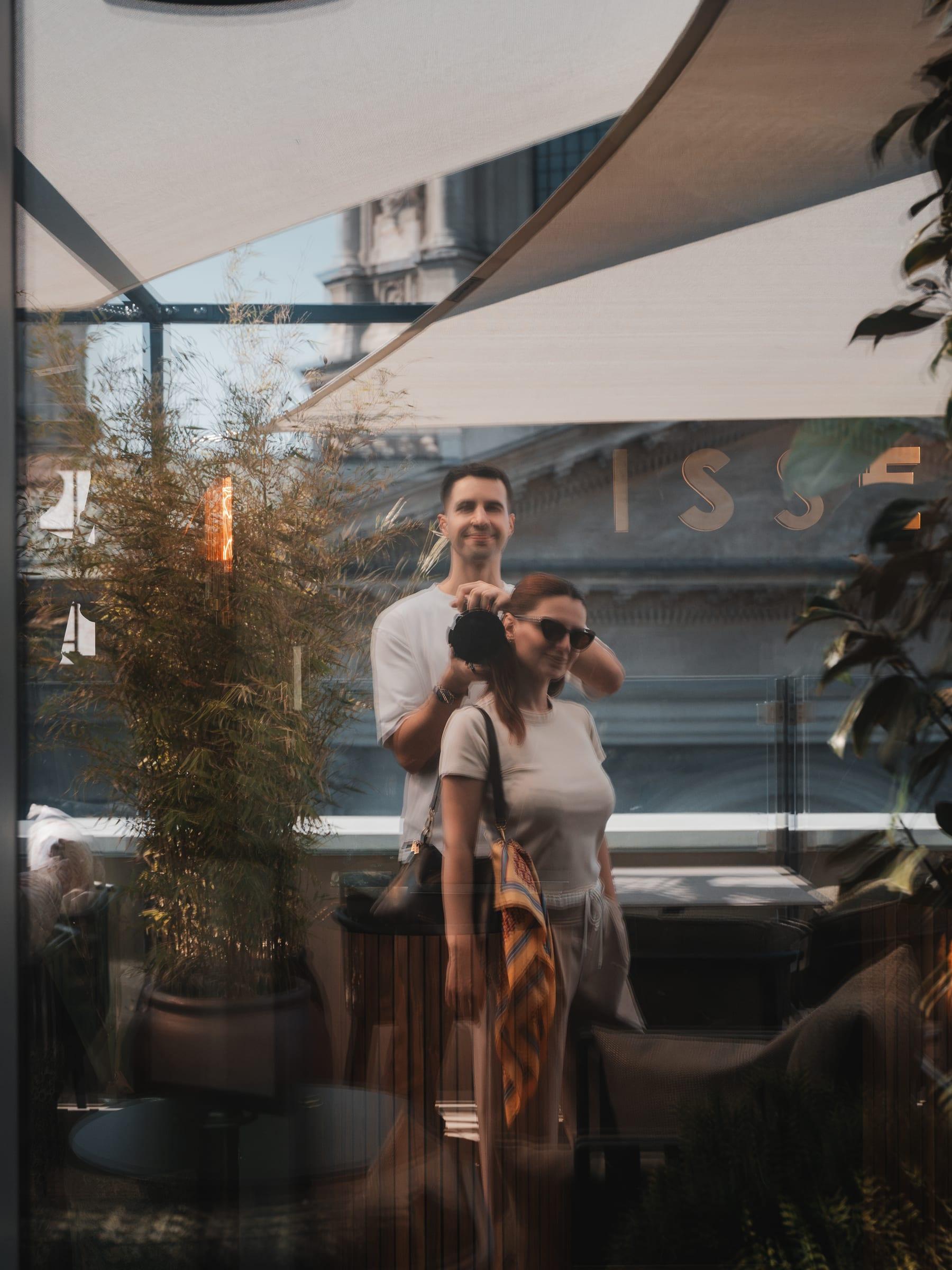 Two of the crew reflected in the glass of the roof terrace