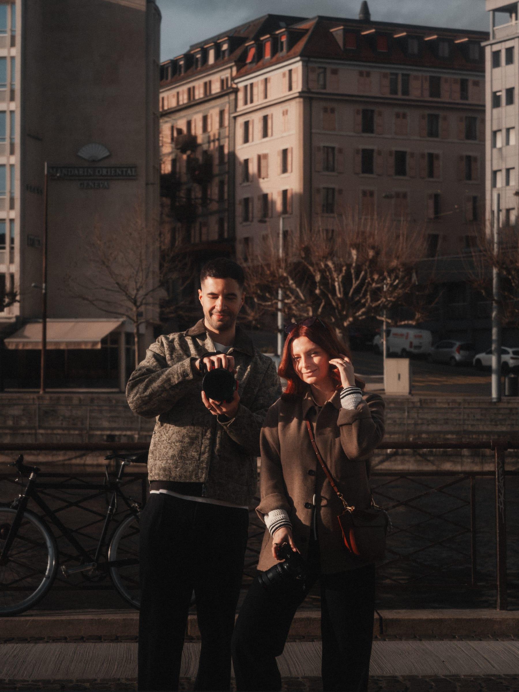 The two of us on the quay checking the back of the camera, the city behind