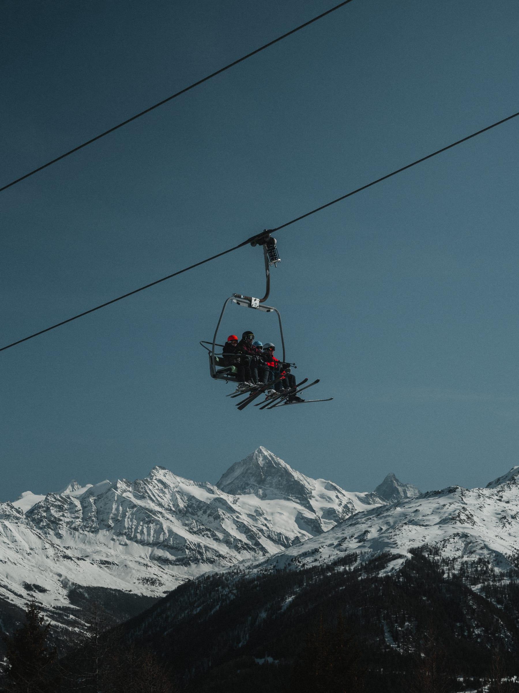 The chairlift crossing a hard blue sky above the summits