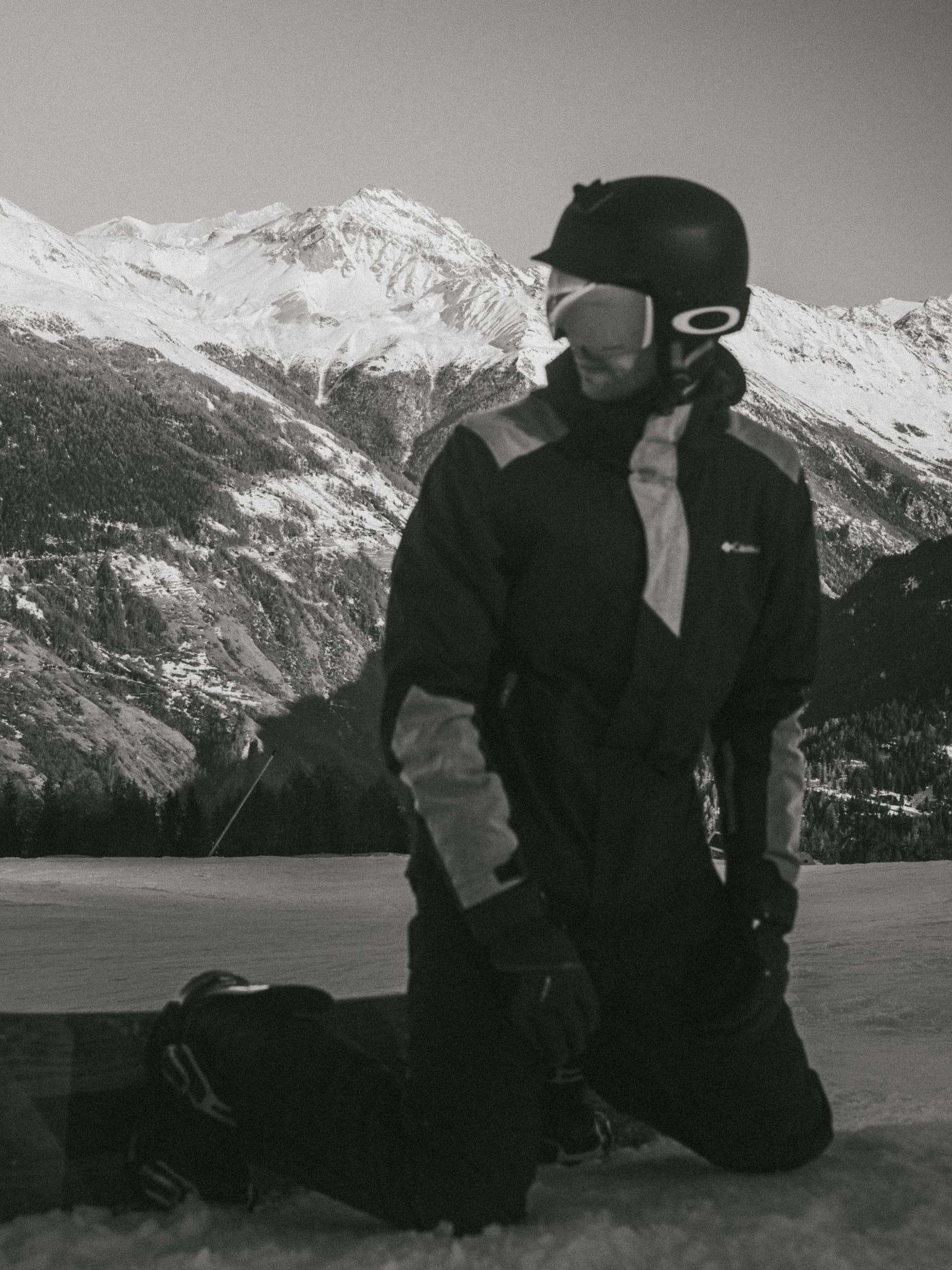 Down on one knee on the piste, strapping in before the next run