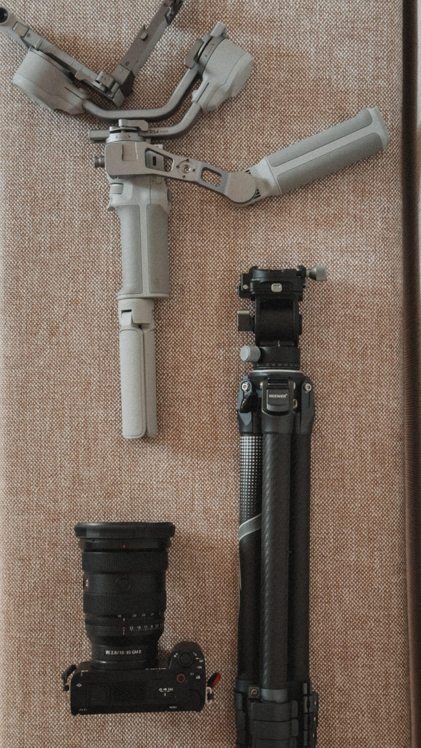 The kit laid out on linen: gimbal, tripod, one prime and a body