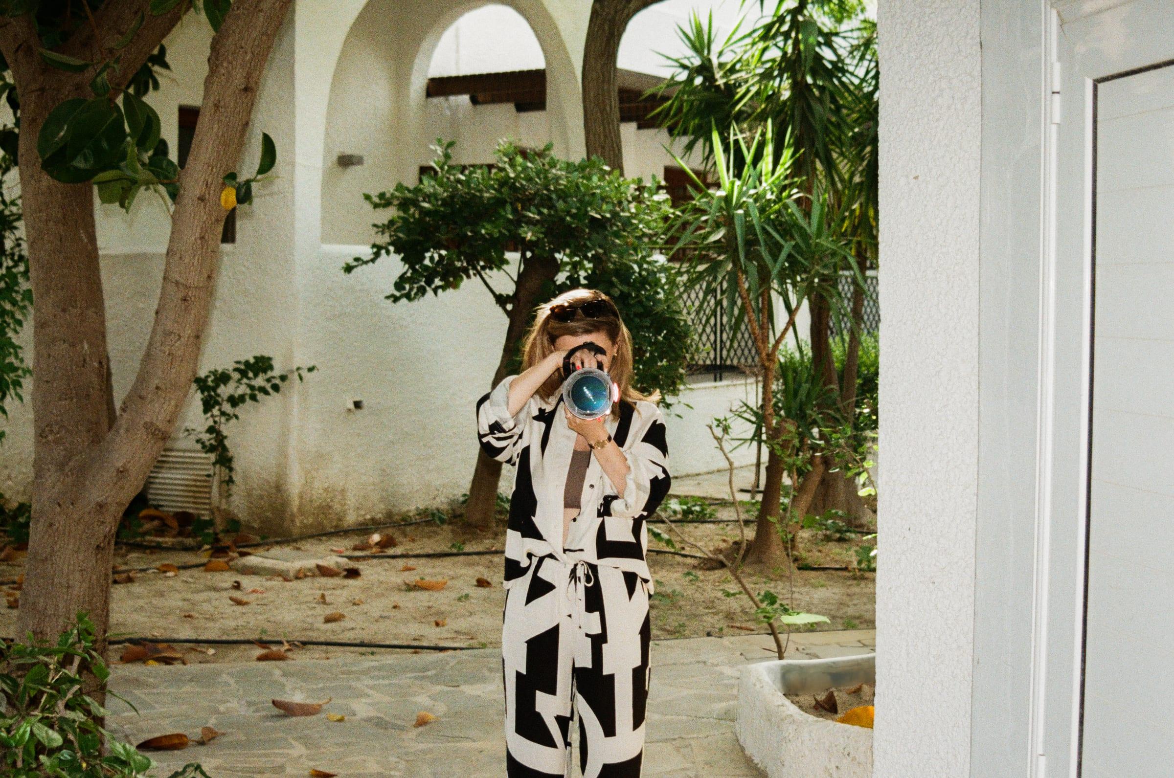 Shooting under the arches in the courtyard, everything bleached out around her