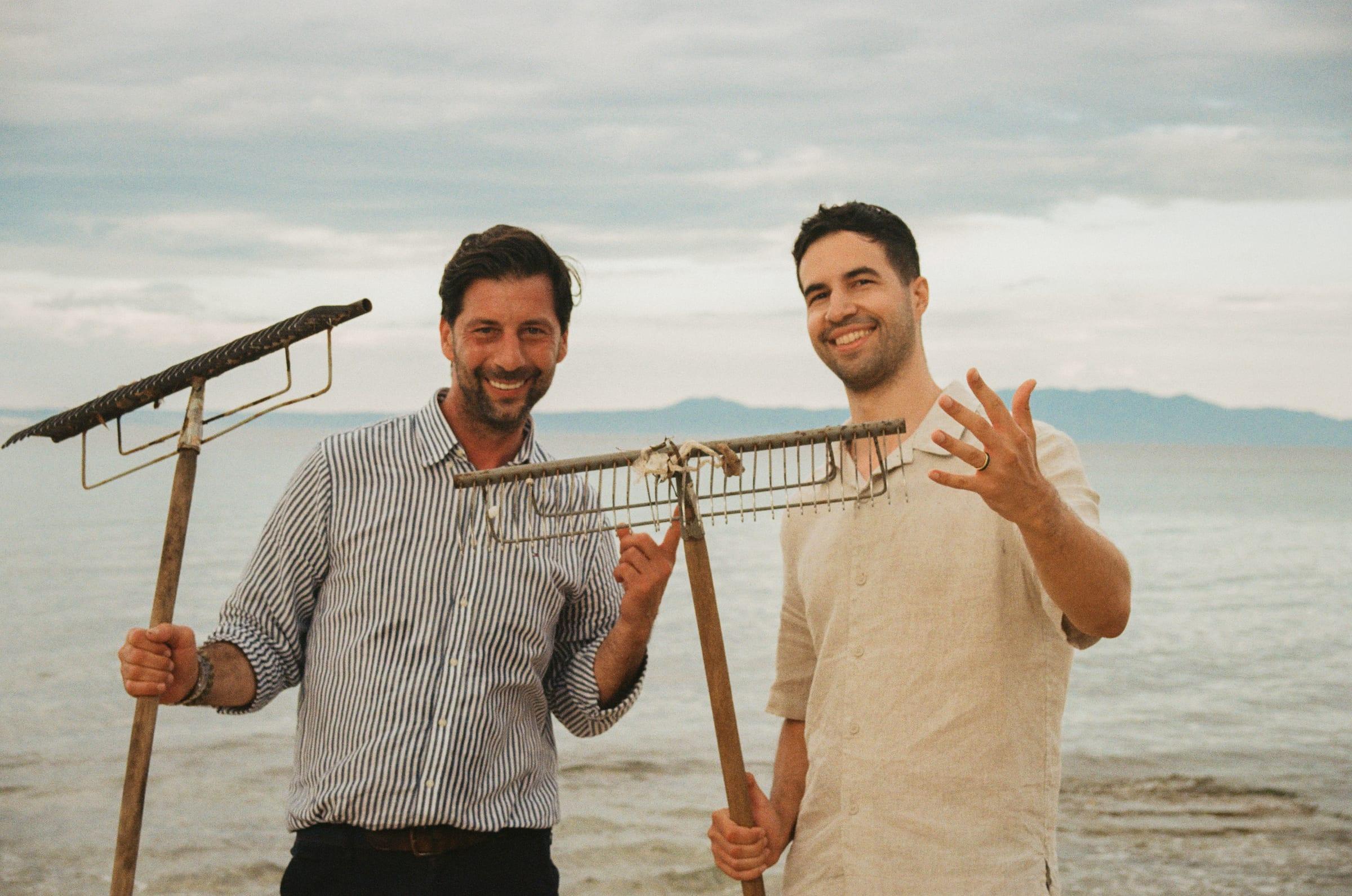 The two of us carrying the slider down onto the beach, the bay flat behind