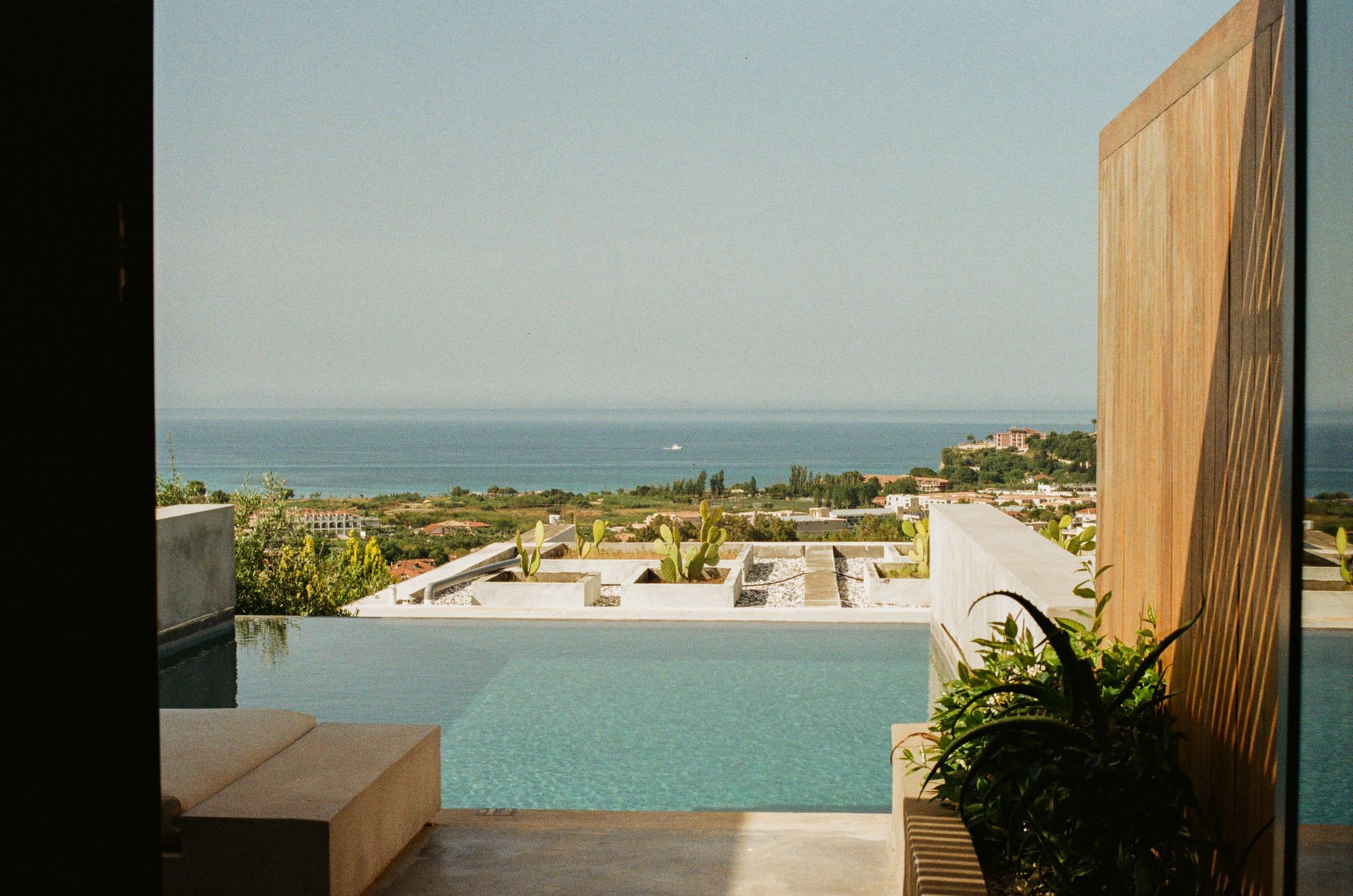 The view straight out of the suite: the pool, the screen, and the sea past both